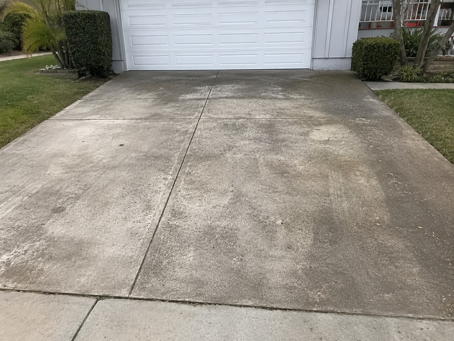 Dirty driveway concrete before Washwell pressure washing